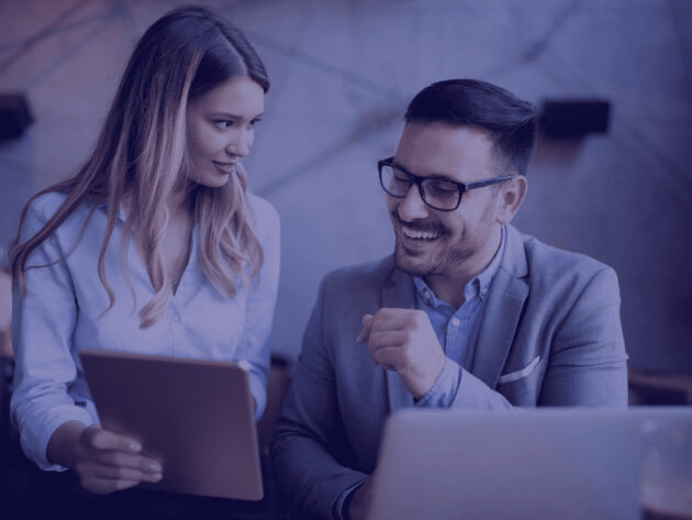 a man and woman looking at a tablet 4 Thresholds of Accounting services for UK Accounting firms